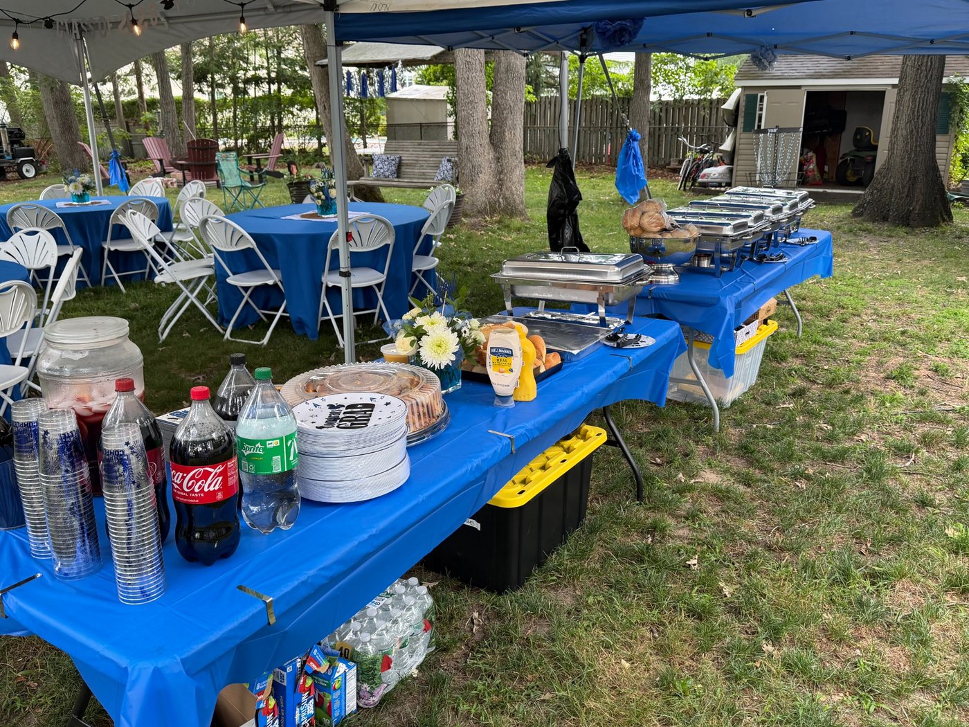 Buffet and party setup under outdoor tents