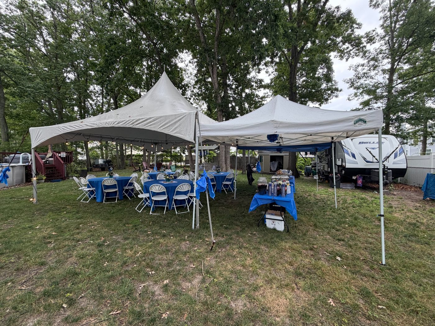 Outdoor graduation party setup with tents